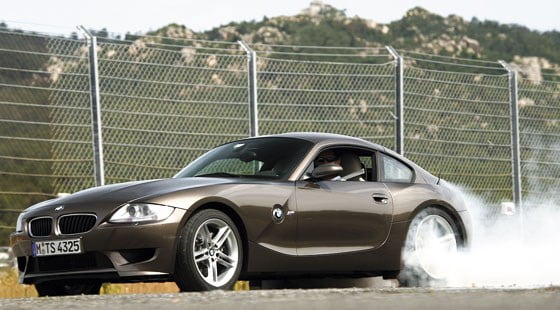 An image of a BMW Z4 with the left rear tyre smoking.