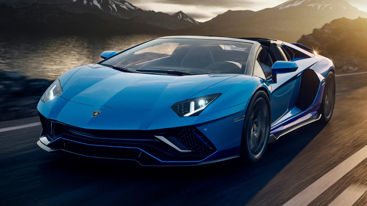 The Lamborghini Aventador LP-780-4 Ultimae Roadster in blue driving on a road.