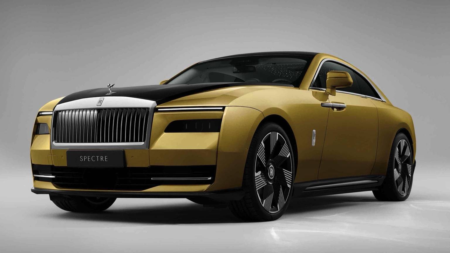 A yellow Rolls Royce Spectre 2023 in yellow with black trims and wheels
