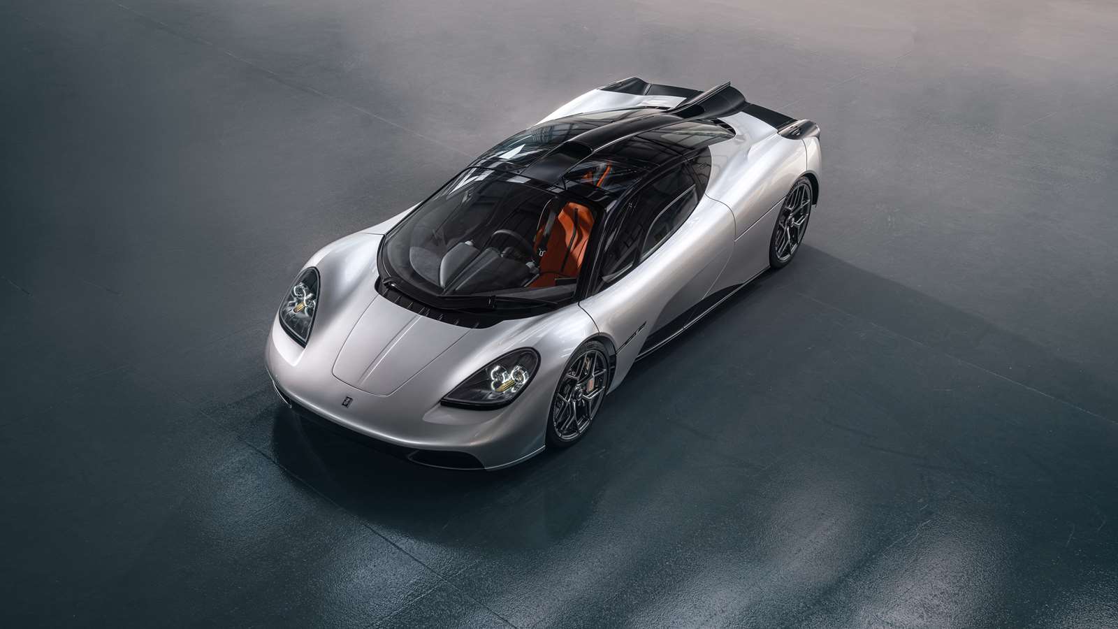 The Gordon Murray Automotive T50 in grey with black accents. The image is taken from above.