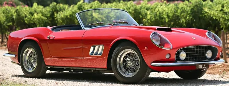 A red 250GT California parked in a rural setting.