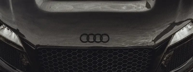 An overhead view of a black Audi with a black Audi badge.