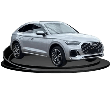 A grey Audi SUV on a podium, against an empty background.