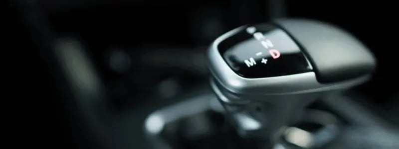 A close up of an automatic gearstick, with different drive settings in view.