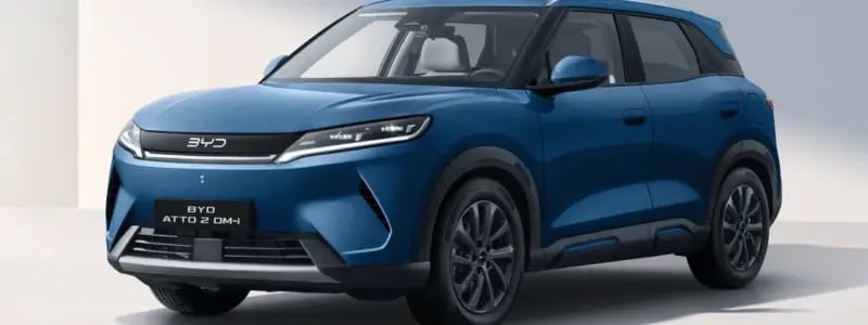 A blue BYD Atto 2 DM-i parked against a white background.