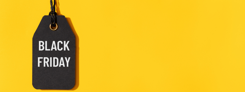 A yellow background with a black tag that reads 'BLACK FRIDAY' on it.