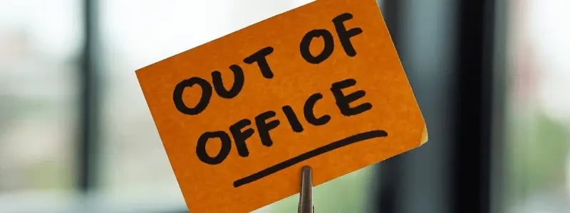 A post-it note reading 'OUT OF OFFICE'.