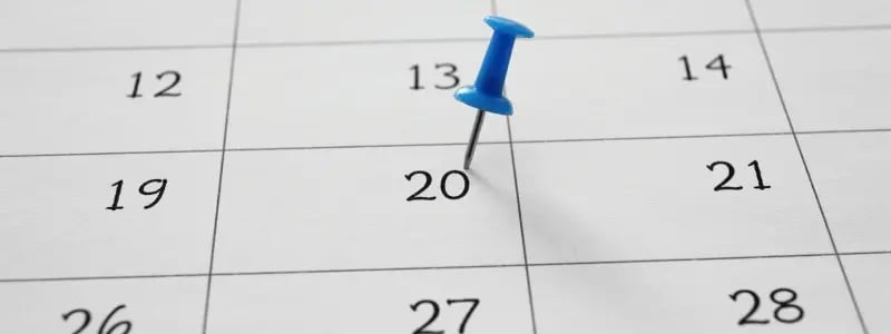 A look at a calendar close up, with a blue pin in the 20th box.