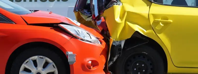 An orange car crashing into a yellow car.
