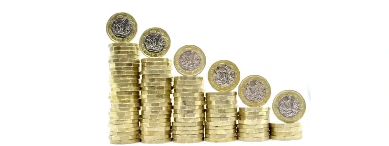 Stacks of coins descending in size from left to right, indicating falling value.