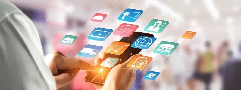 A person using a phone with floating icons, representing different communication channels.
