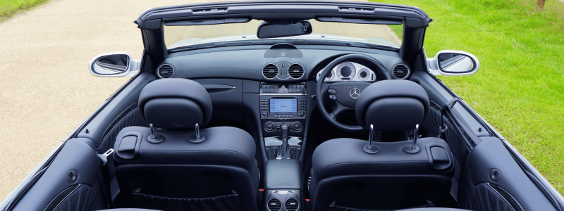 An overhead view of a Mercedes convertible car, with a black finish throughout.
