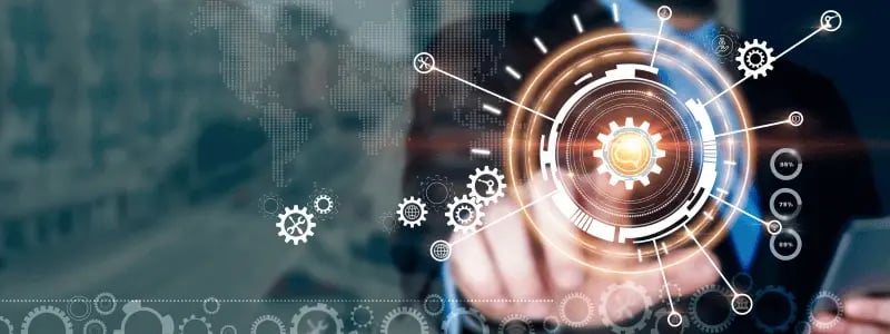 Businessman interacts with futuristic digital interface of interconnected gears, symbolising automation, optimisation, and digital transformation.