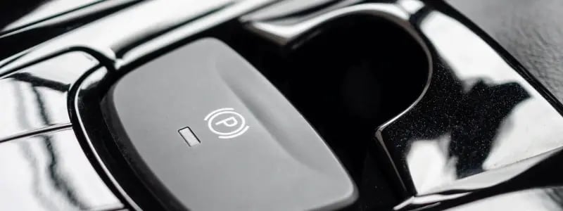A close up of an electronic handbrake in a car.