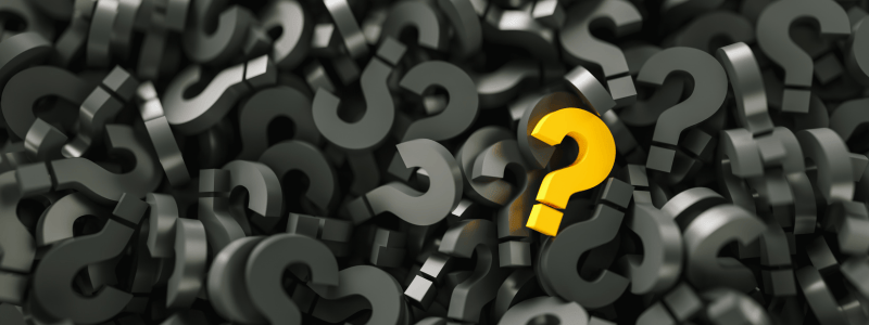 One yellow question mark amongst a sea of black question marks.