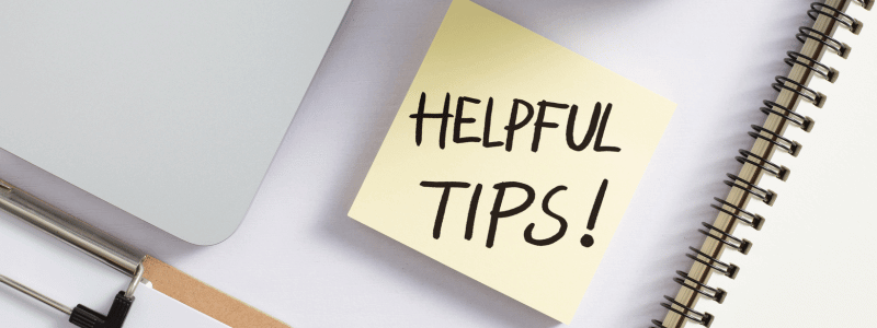 A post it note on a desk, with 'HELPFUL TIPS!' written on.