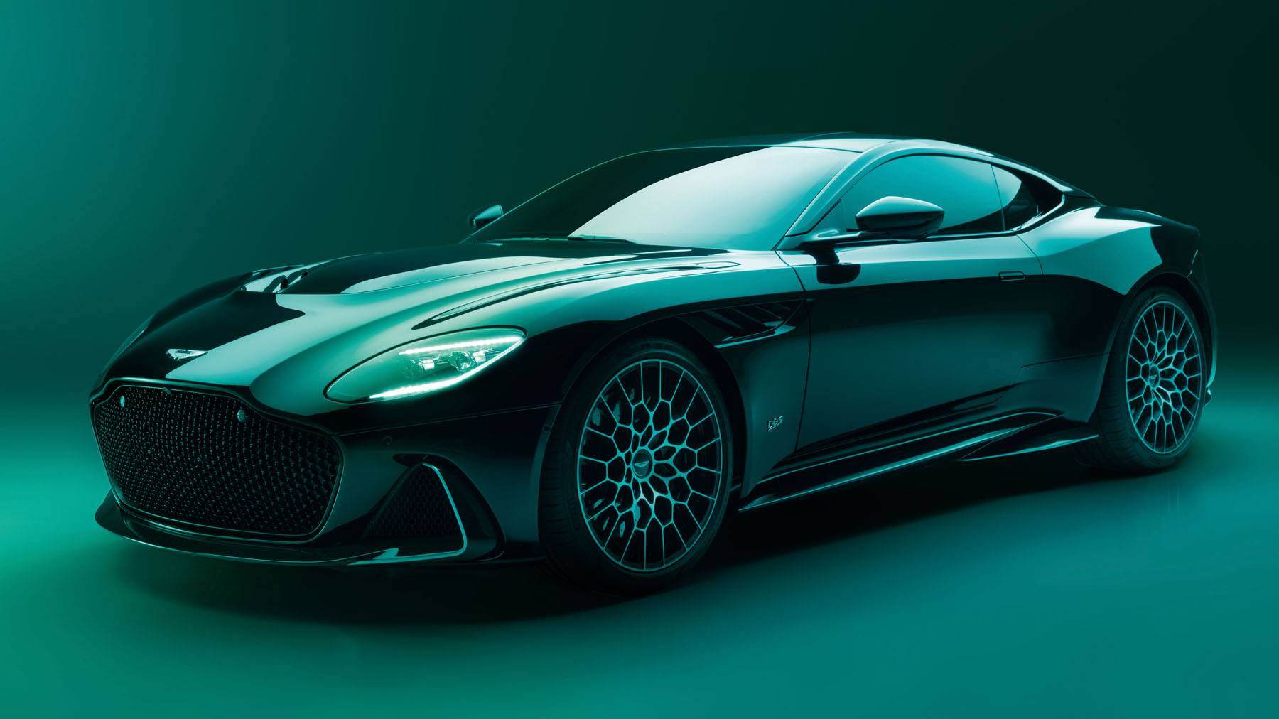 The Aston Martin DBS parked up with a green glow shining all over it.