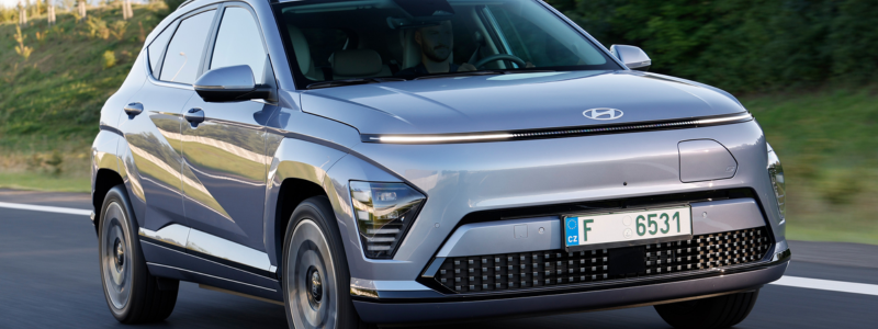 A grey Hyundai Kona Electric on a road.