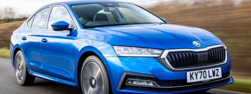 Blue sedan car in motion on a road, representing a dynamic driving experience.