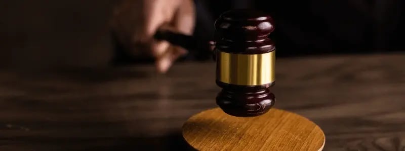 A close up of someone hitting a hammer in a courtroom.