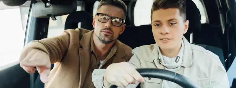 A learning instructor guides a learner driver.