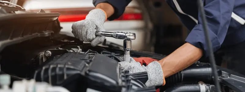A mechanic working on a car engine.