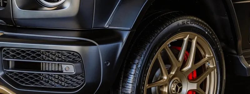 A close up of a Mercedes Benz G Class tyre in gold.