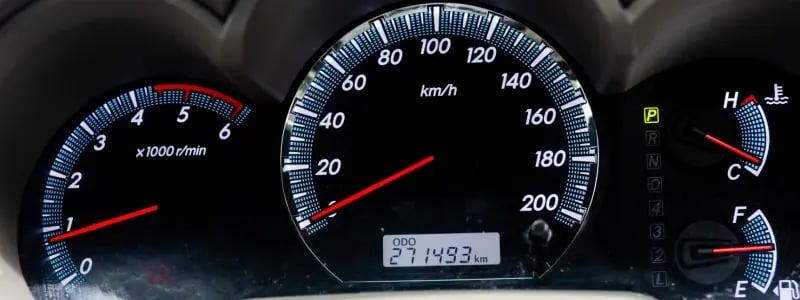 A car dashboard displaying the odometer and speed gauge.