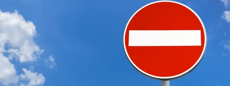 A no entry sign against a blue sky background.