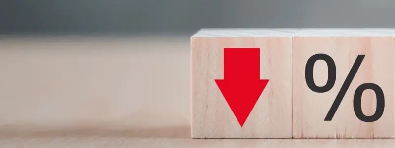 Two blocks connected. One with a percentage sign drawn on, the other with a red downward arrow, symbolising a falling trend.
