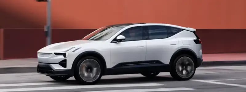 A light grey Polestar SUV driving on a road.