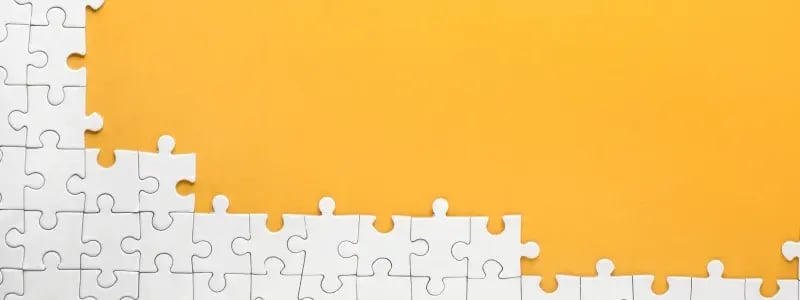 Pieces of a puzzle being put together, against a yellow background.