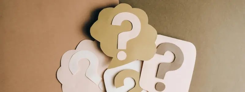 A stack of question marks on seperate pieced of card.
