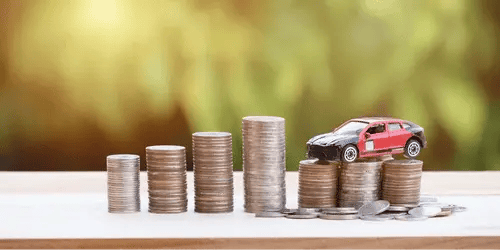 A model car on stacks of coins.