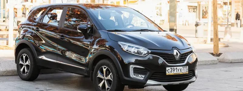 A black compact SUV parked in a city setting.