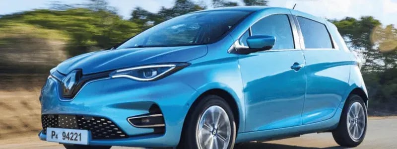 A blue Renault Zoe driving on a rural road.