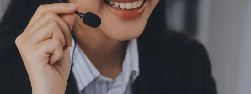 A close up of a someone using a headset in a work setting.