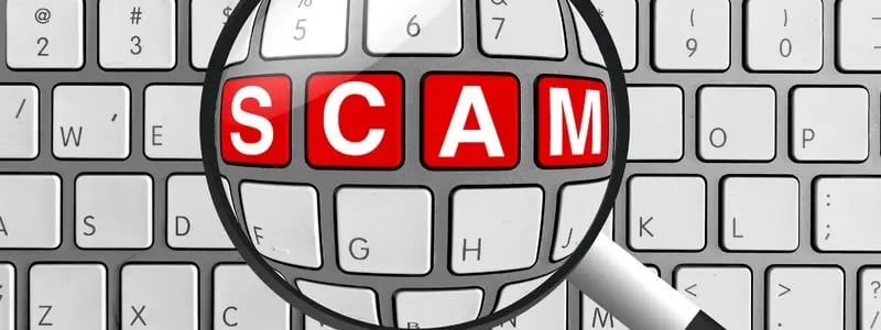 A magnifying glass in effect hovering over a keyboard, with 4 red letters in a line reading 'SCAM', symbolising scam detection on computers and laptops.