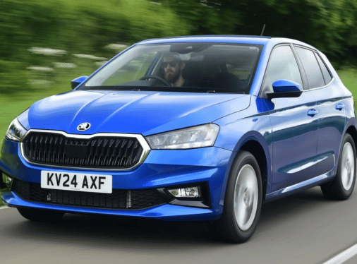 A blue Skoda Fabia driving on a road.