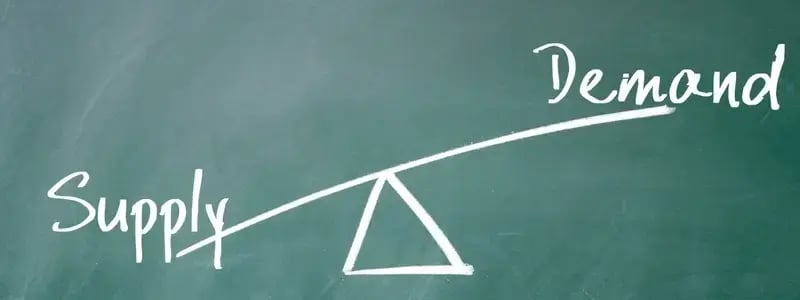 Supply and demand on a chalkboard scales, with demand outweighing supply.
