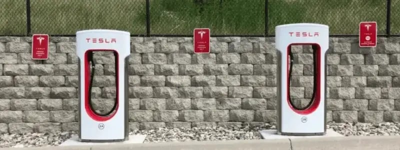 Two Tesla superchargers in a built up area.