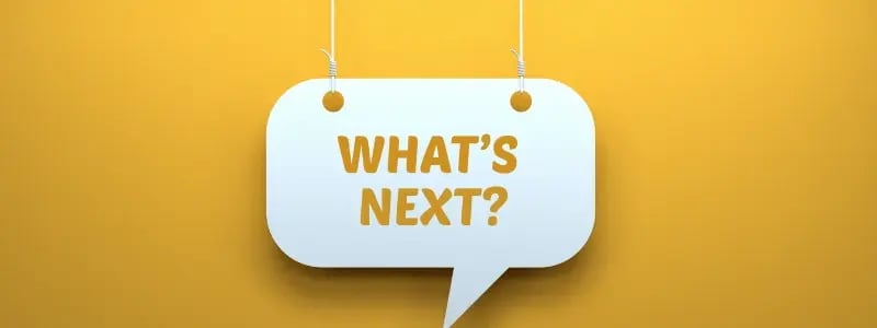 A white sign hanging down against a yellow background, with yellow text on the sign reading 'WHAT'S NEXT?'