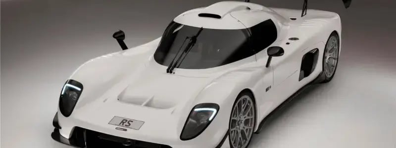 A white Ultima car in a showroom setting.