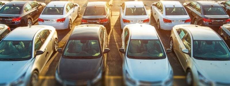 Rows of cars with sun light shining down.
