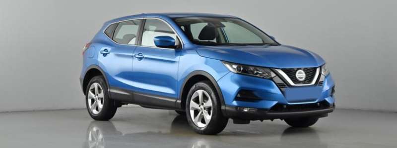 A blue Nissan Qashqai parked in a grey space.