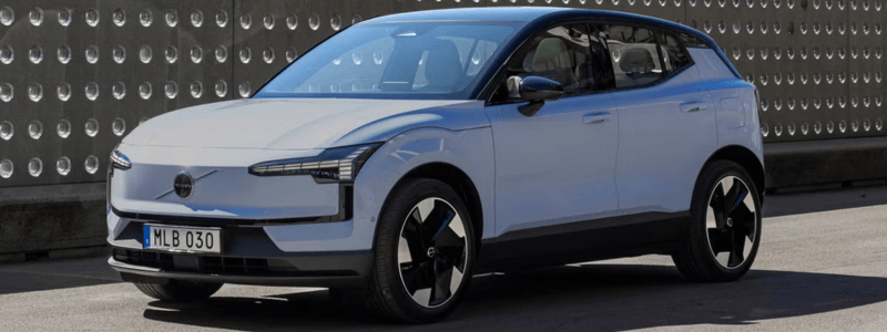 A white Volvo in an industrial setting.