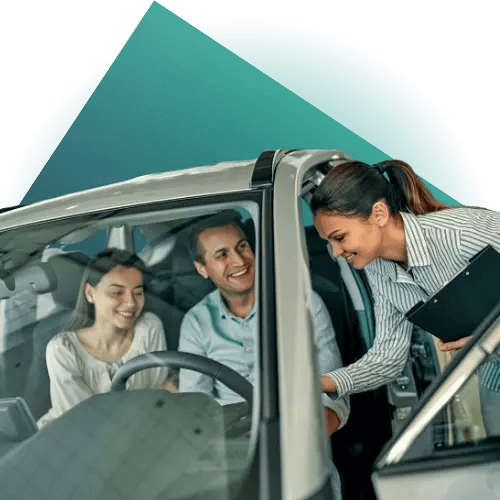 A couple speaking to a car dealer with a teal geometric shape in the background.