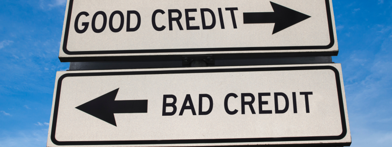 Road signs pointing in different directions with good credit on one and bad credit on the other.