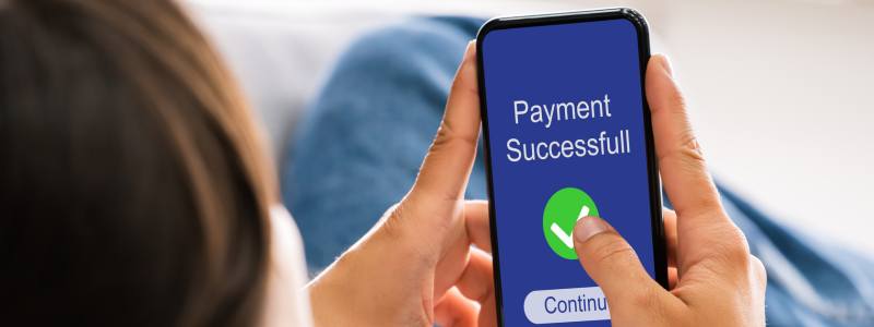 A person receives a message saying their payment was successful, via their phone.