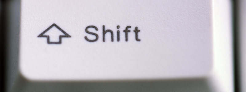 A close-up of a shift key on a classic key board.